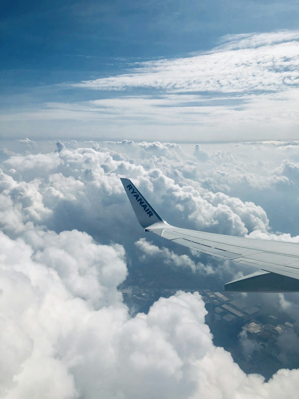 Ryanair-Flugzeugflügel über den Wolken