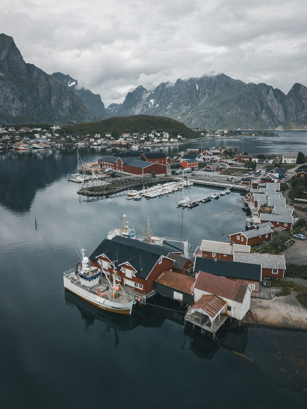 brown and white houses beside body of water at daytime