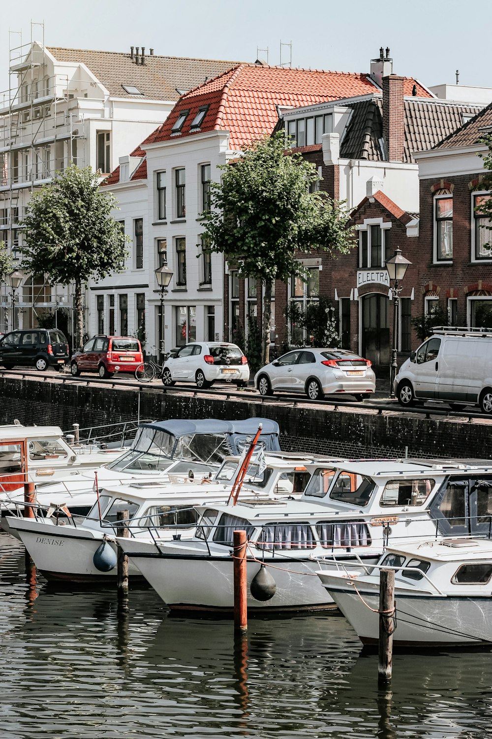 several boats docked beside road