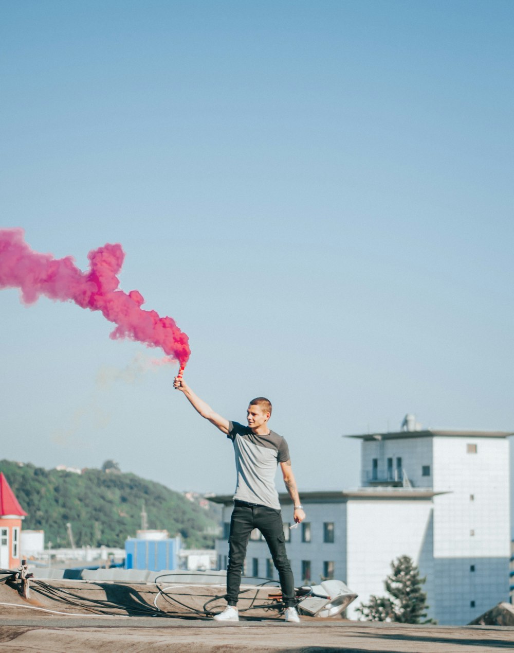 man holding pink smoke
