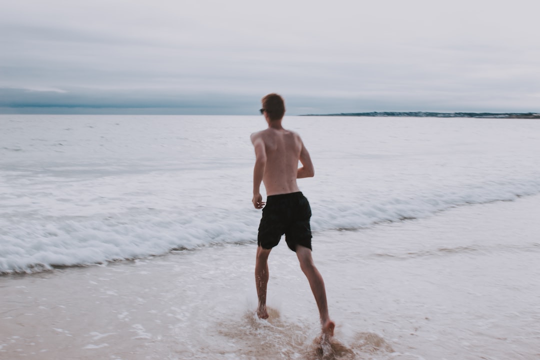 man running on seashore