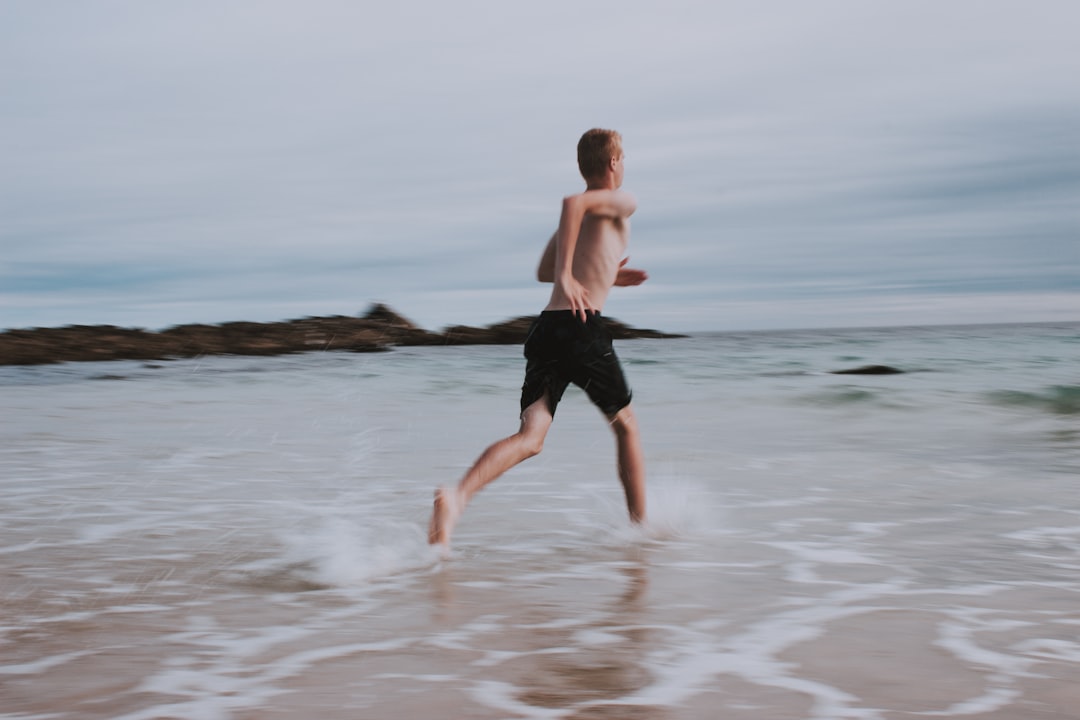 man running on seashore