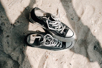 A pair of stylish sneakers resting on a clean white surface with subtle shadows.