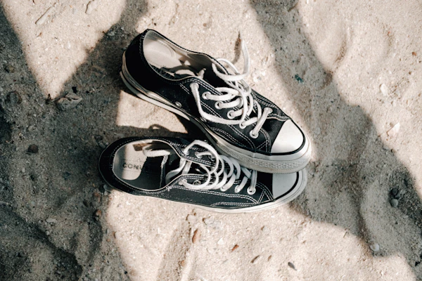 A pair of stylish sneakers resting on a clean white surface with subtle shadows.