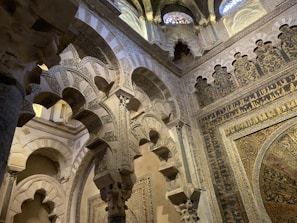 The majestic arches and delicate arabesques inside the mosque-cathedral of Córdoba, blending faiths in stone.