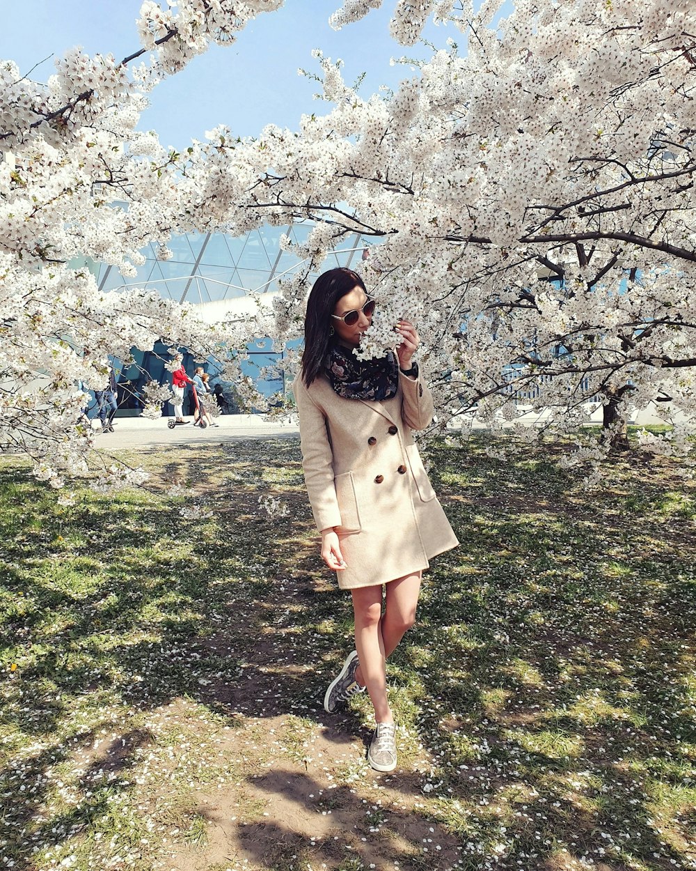 woman wearing coat standing near tree