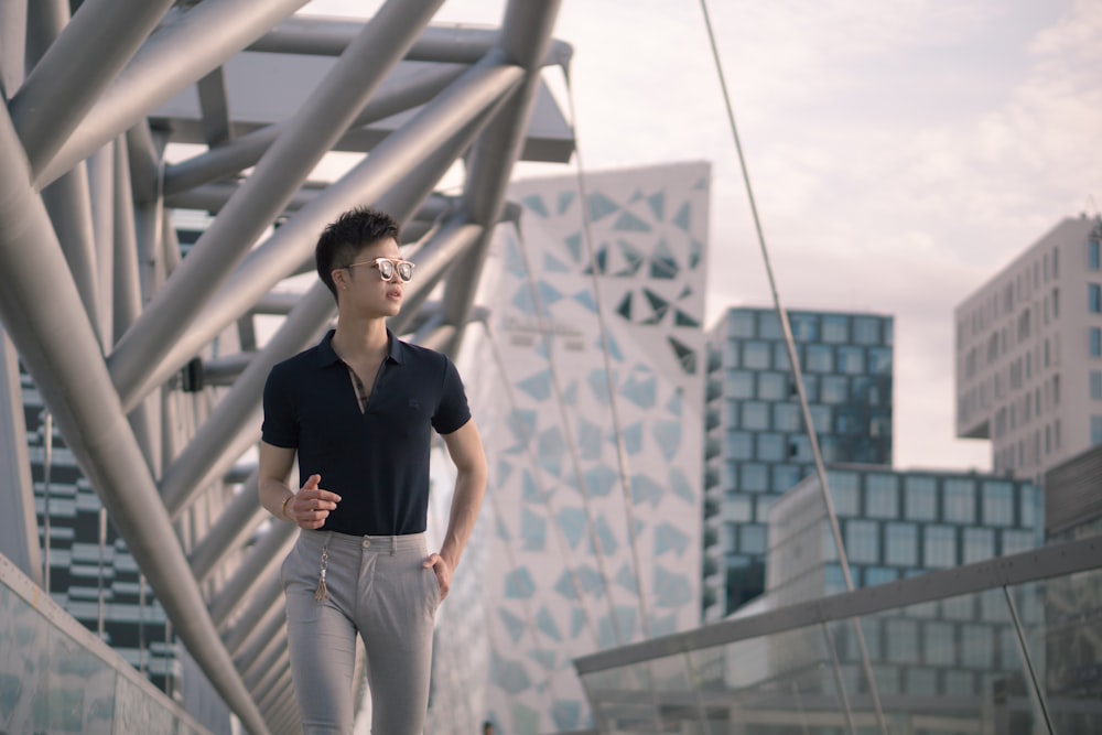 man wearing black shirt and grey pants