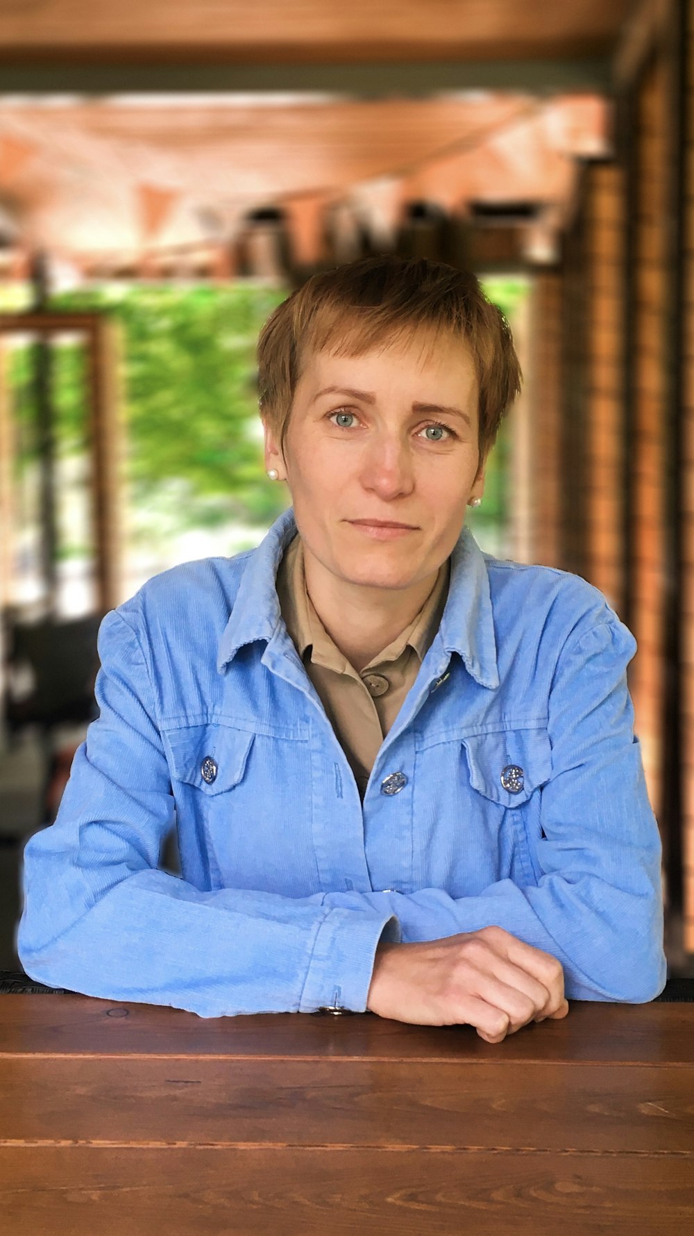 woman wearing blue denim jacket looking straight