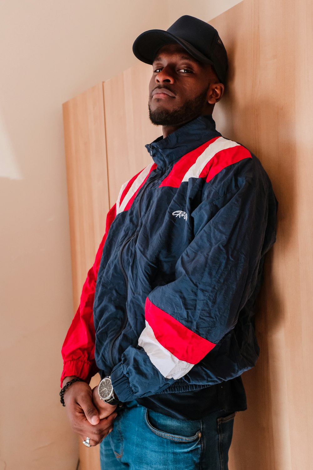 men's black, red, and white jacket close-up photography