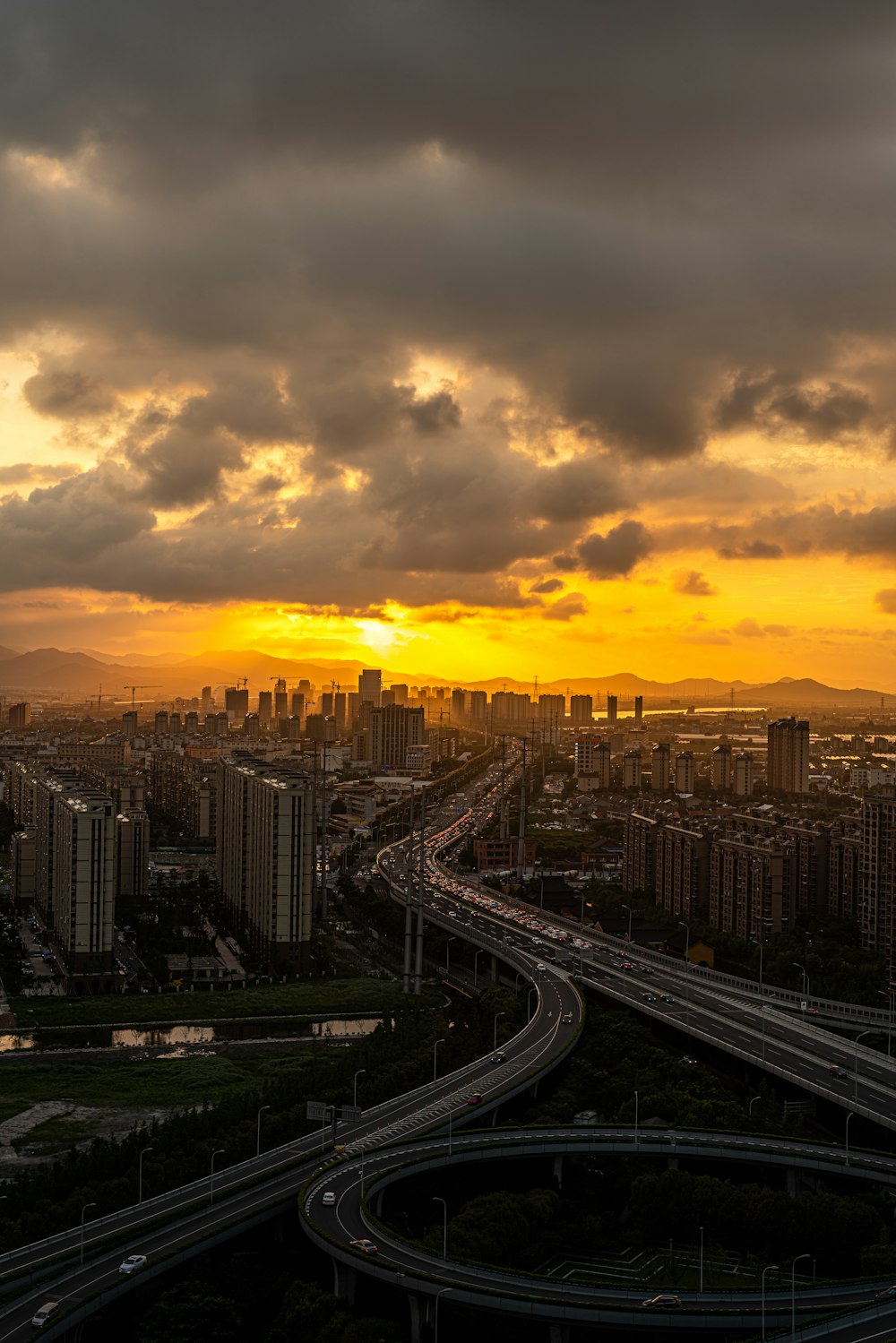 city with high-rise buildings under gray and yellow skies