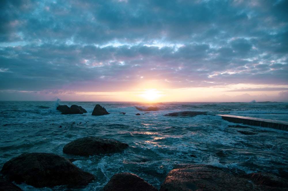 calm body of water during sunrise