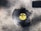 A broken vinyl record with a yellow MGM label is lying on a rough, textured concrete surface. Pieces of the record are missing, suggesting it has been shattered.