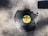 A broken vinyl record with a yellow MGM label is lying on a rough, textured concrete surface. Pieces of the record are missing, suggesting it has been shattered.