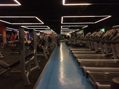 A vibrant gym filled with happy clients and trainers working together energetically.