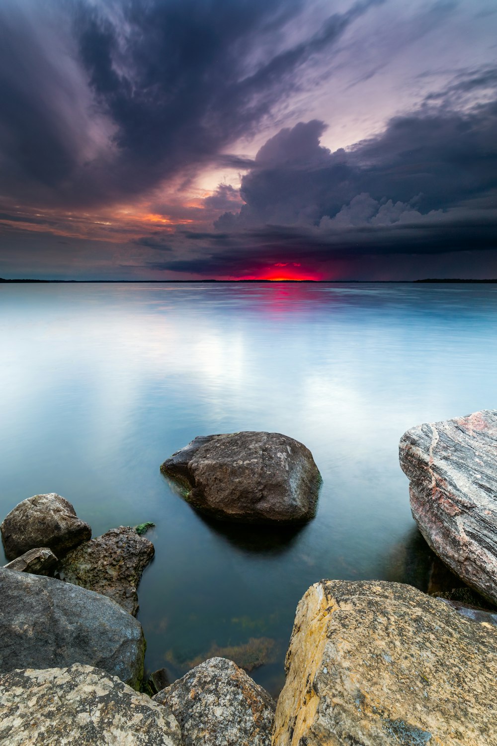 rock beside body of water during daytime