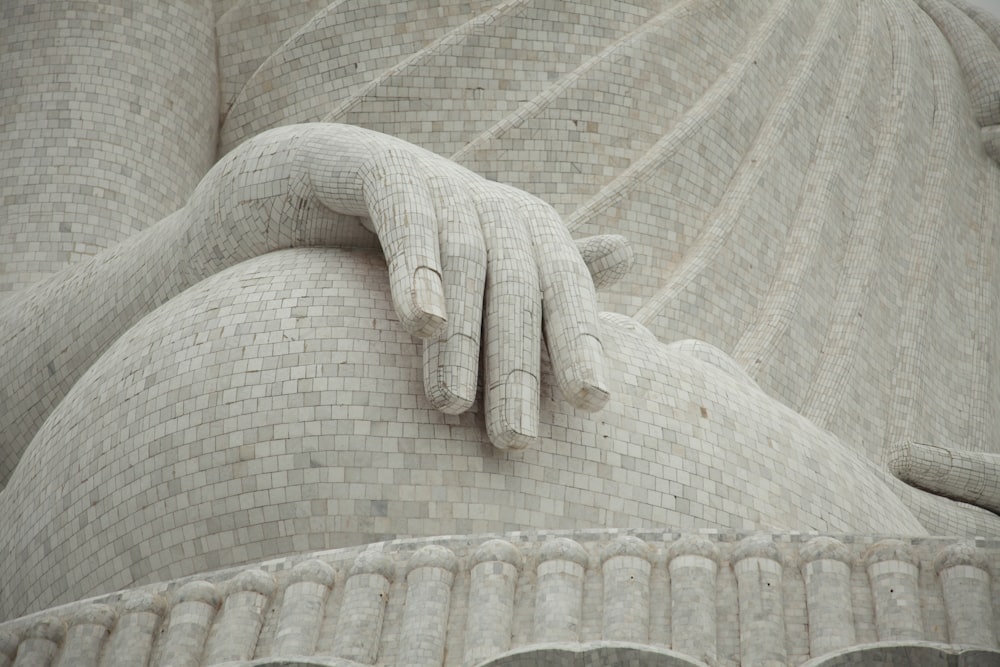 a close up of a statue of a person with a hand on it's