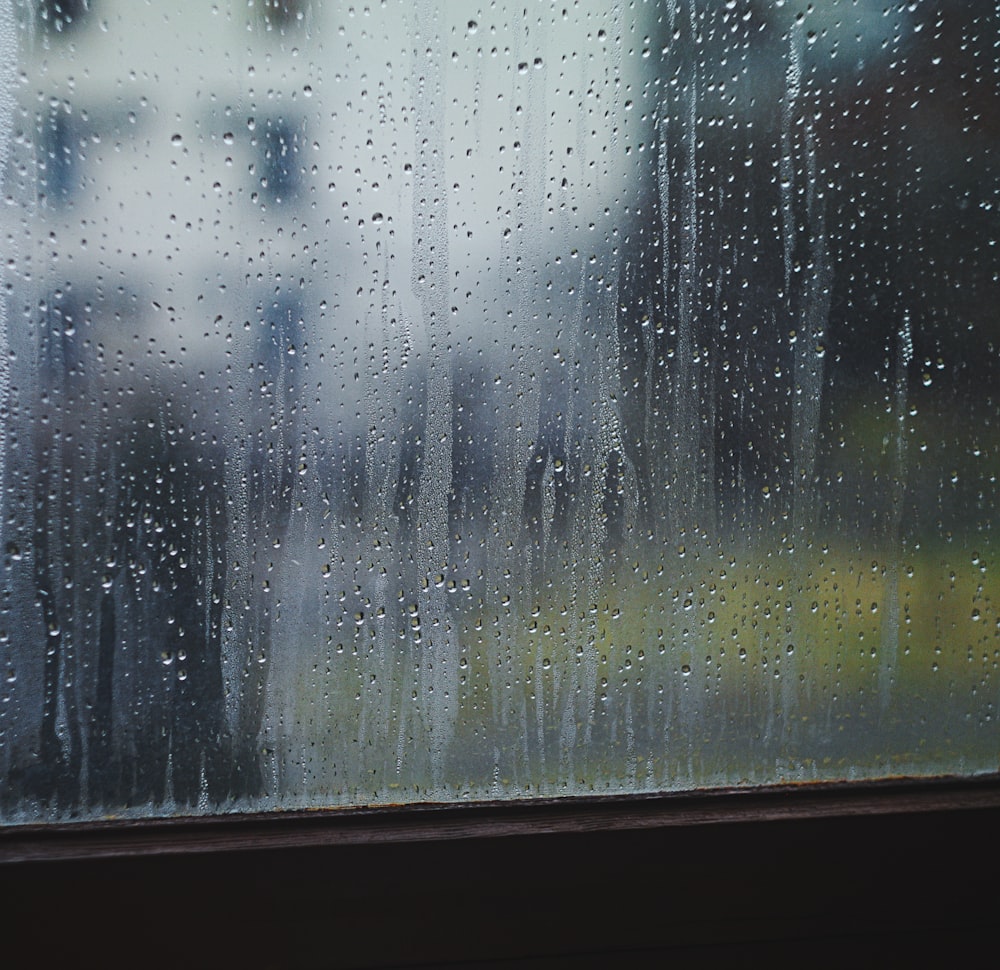 closeup photo of pane window with raindrops