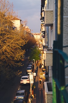 A vibrant urban street scene captured at golden hour with warm light and lively colors.