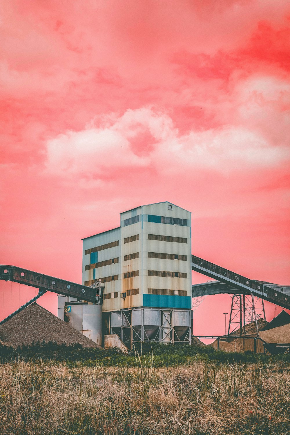 white concrete building under pink sky