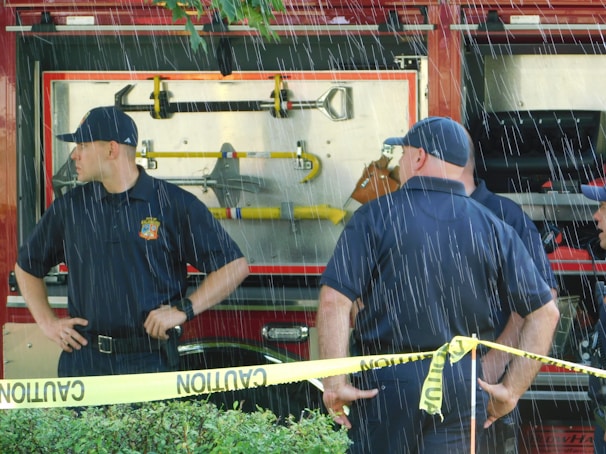 Water damage restoration crew unloading equipment from a company truck at a job site.