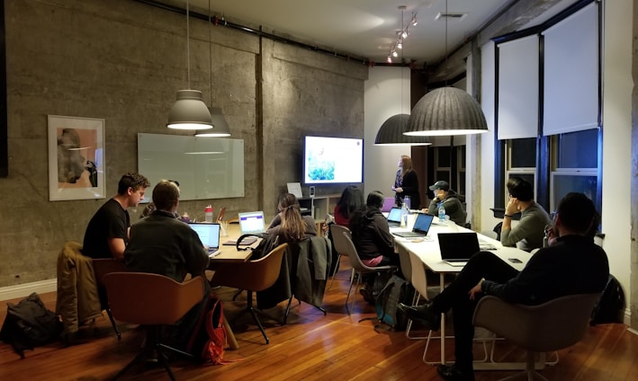 people sitting and using laptops