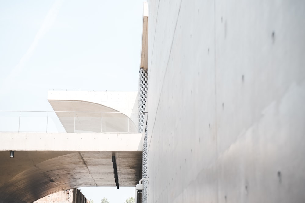 a man riding a skateboard down a street under a bridge