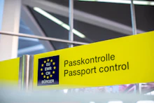Travelers lining up at airport passport control