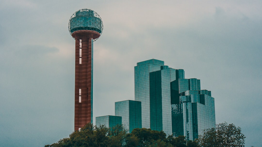 grey concrete buildings, Reunion Tower stands tall over the Hyatt Regency Hotel (May, 2009).
