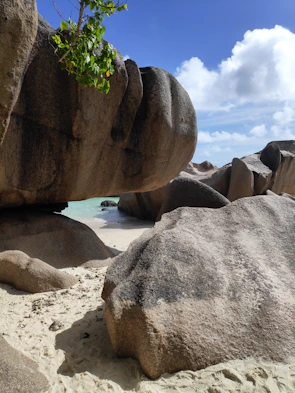 gray and black rock formations under white and blue sky at daytime