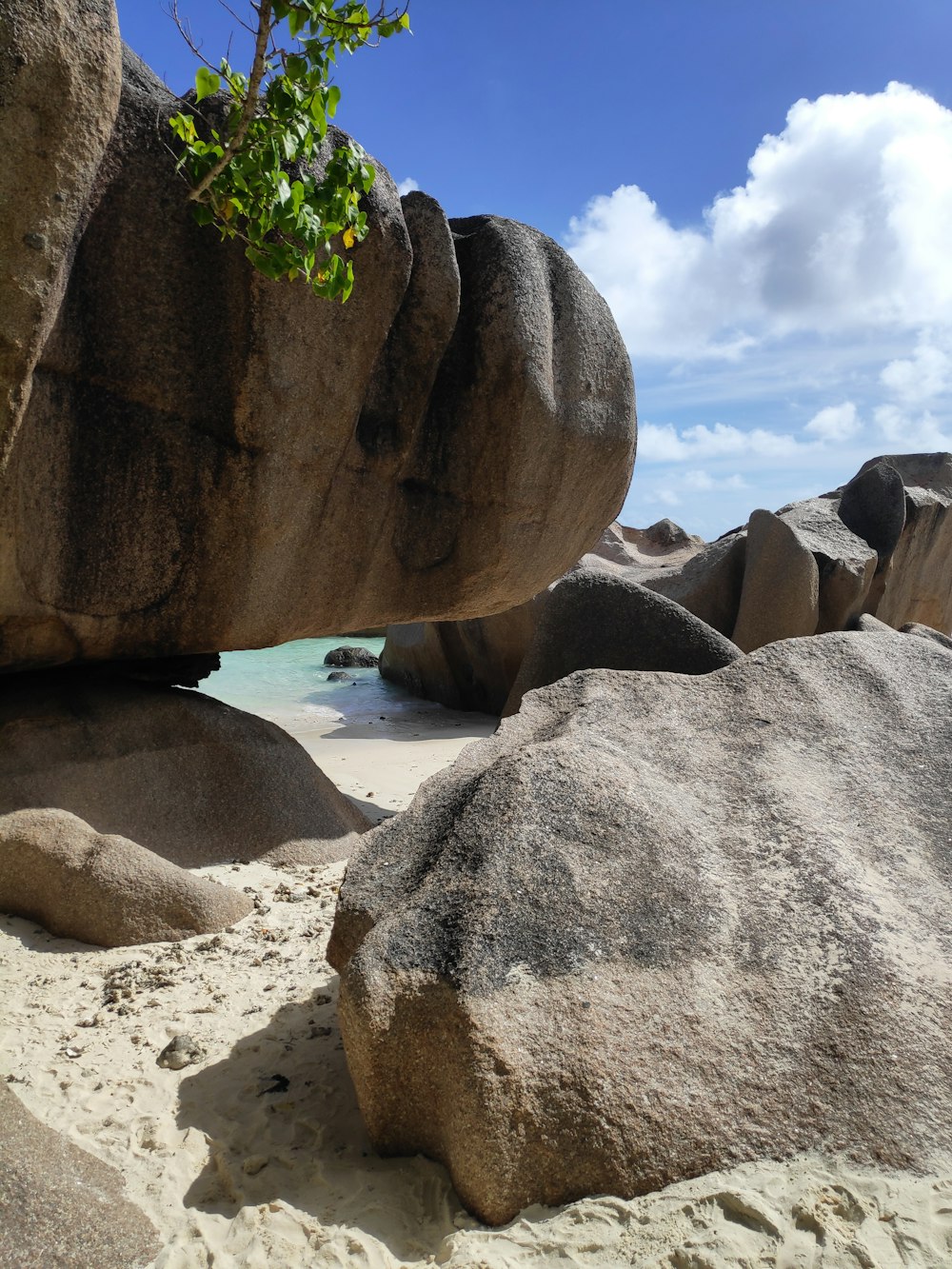 gray and black rock formations under white and blue sky at daytime