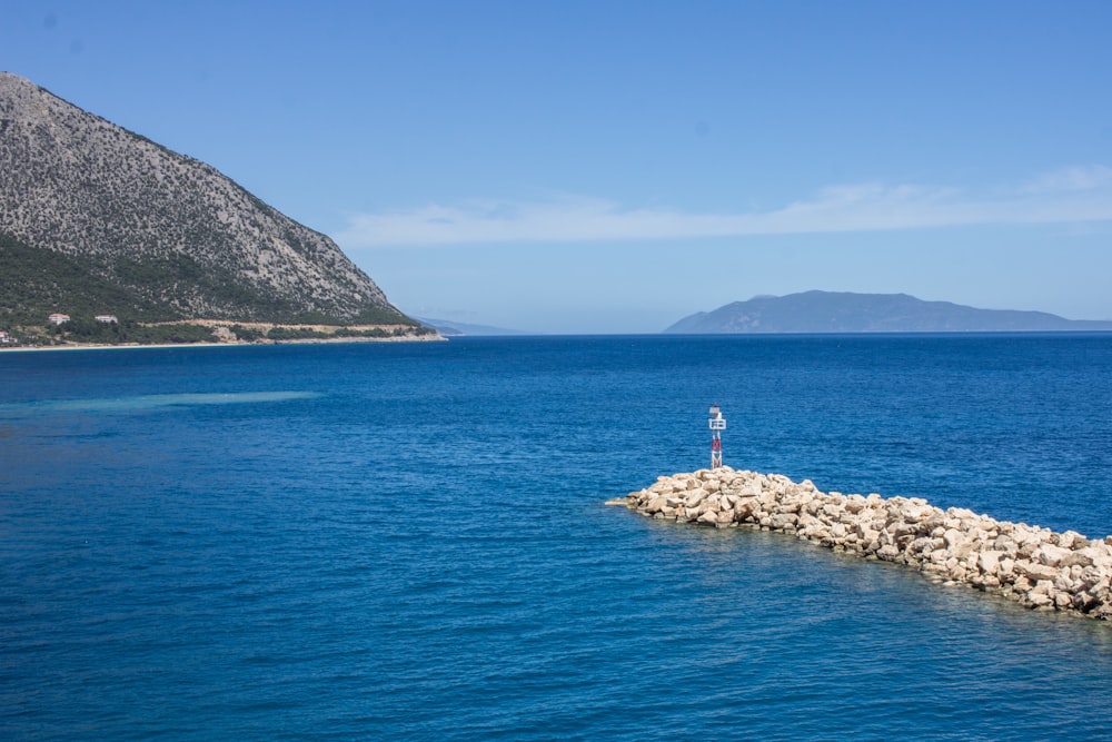 photography of seashore and mountain during daytime