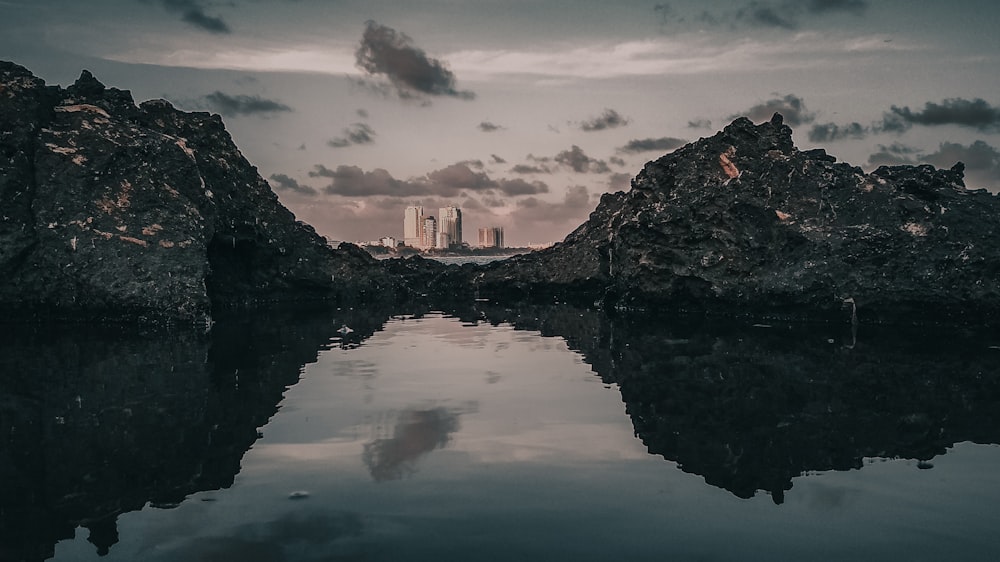 body of water and mountain cliff