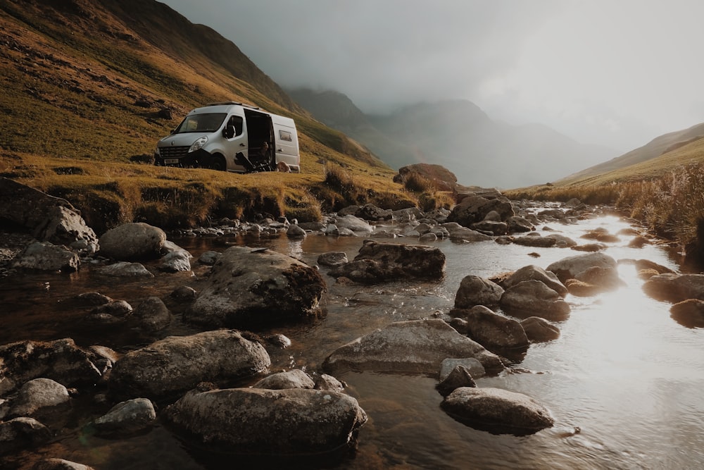 white van near body of water