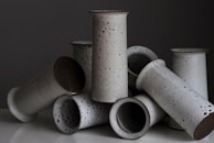 A close-up of handcrafted ceramic vases in soft pastel tones, arranged artfully.