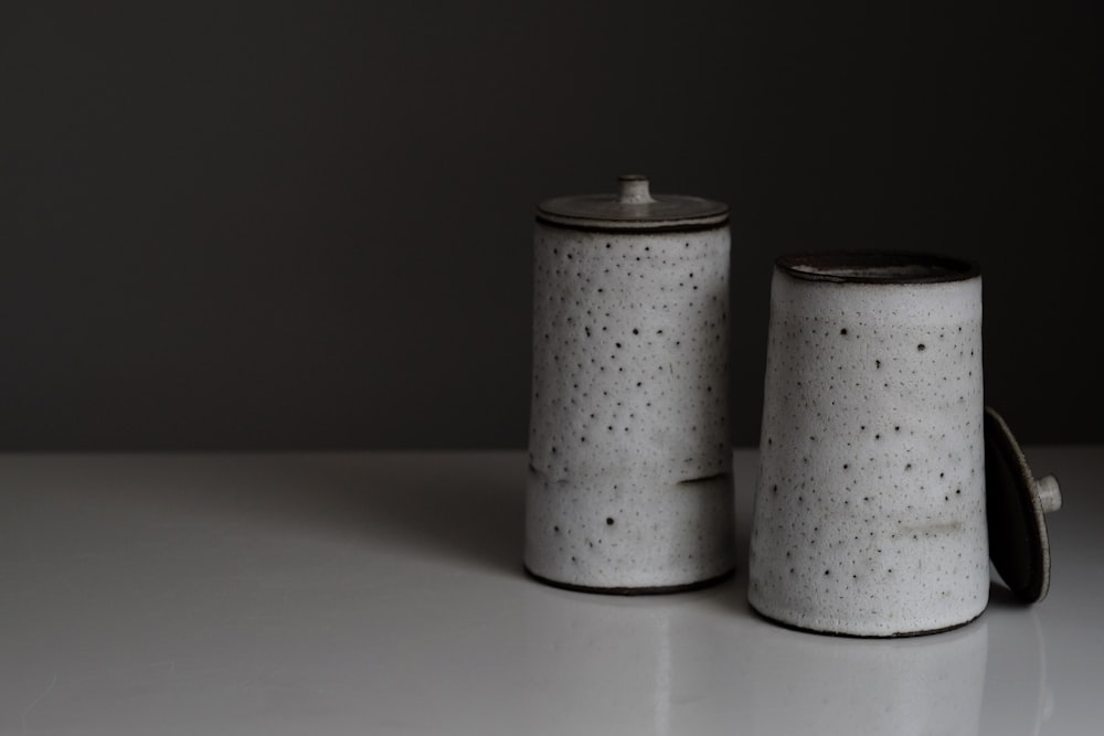 two grey canisters