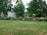 A freshly trimmed front yard with vibrant flower beds and neatly edged lawn under a bright sky.