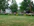 Beautifully designed backyard with lush green lawn and colorful flower beds.