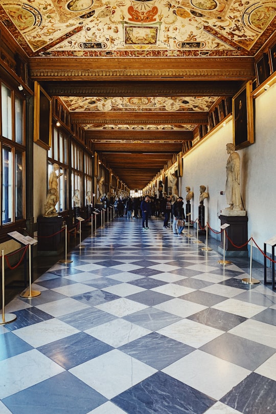 photography of people gathering inside building in Uffizi Gallery Italy
