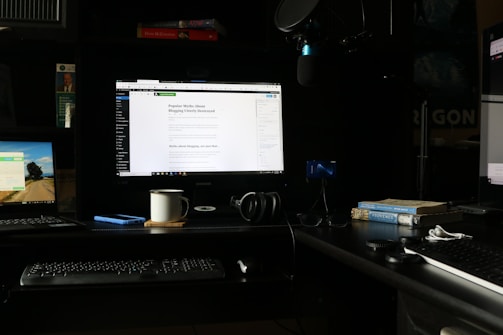 A cozy workspace with multiple tech devices open, showing a blogger deeply engaged in writing a review.