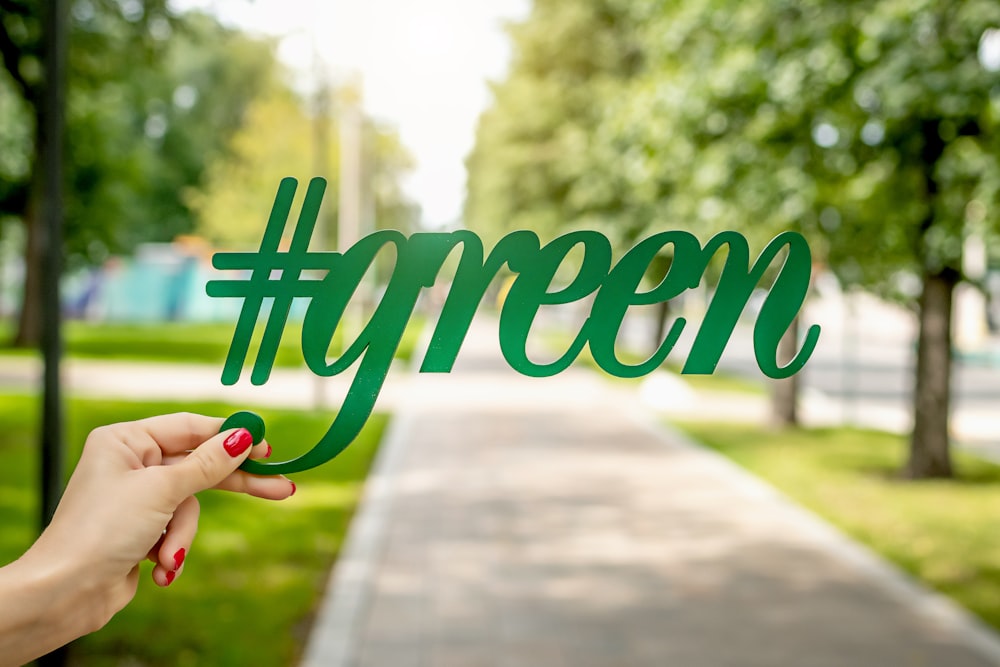 person holding green signage