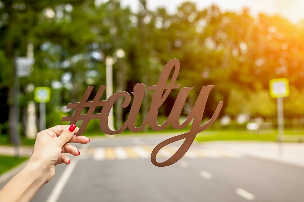 person holding #City cutout letter