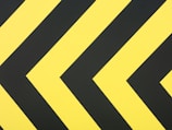 a close up of a yellow and black arrow sign