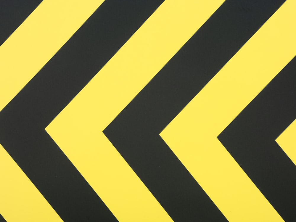 a close up of a yellow and black arrow sign