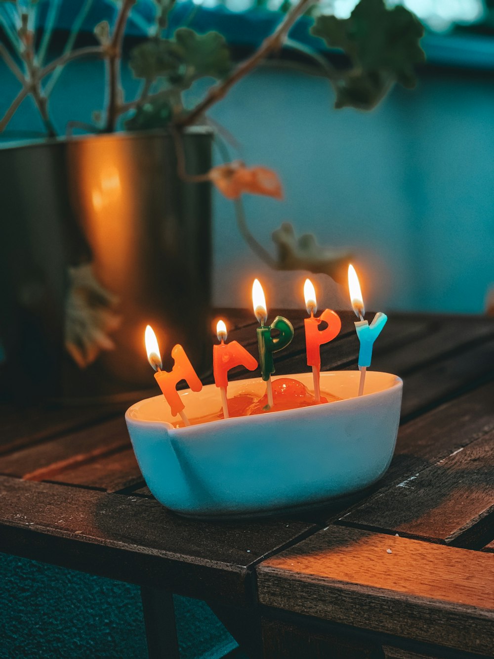 happy letter candles on white container