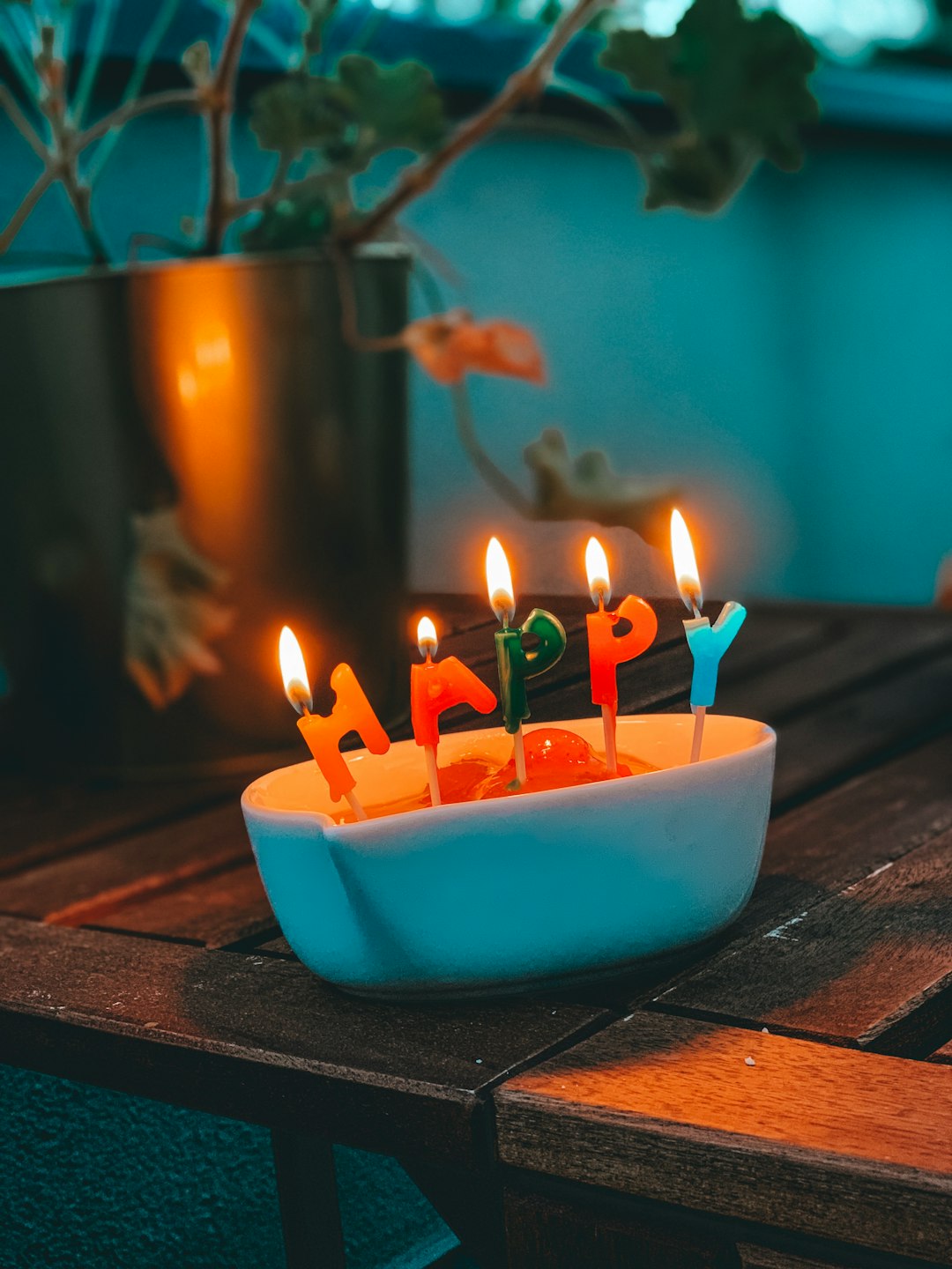 happy letter candles on white container