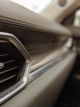 Close-up of a shiny car dashboard highlighting clean, fresh interiors.