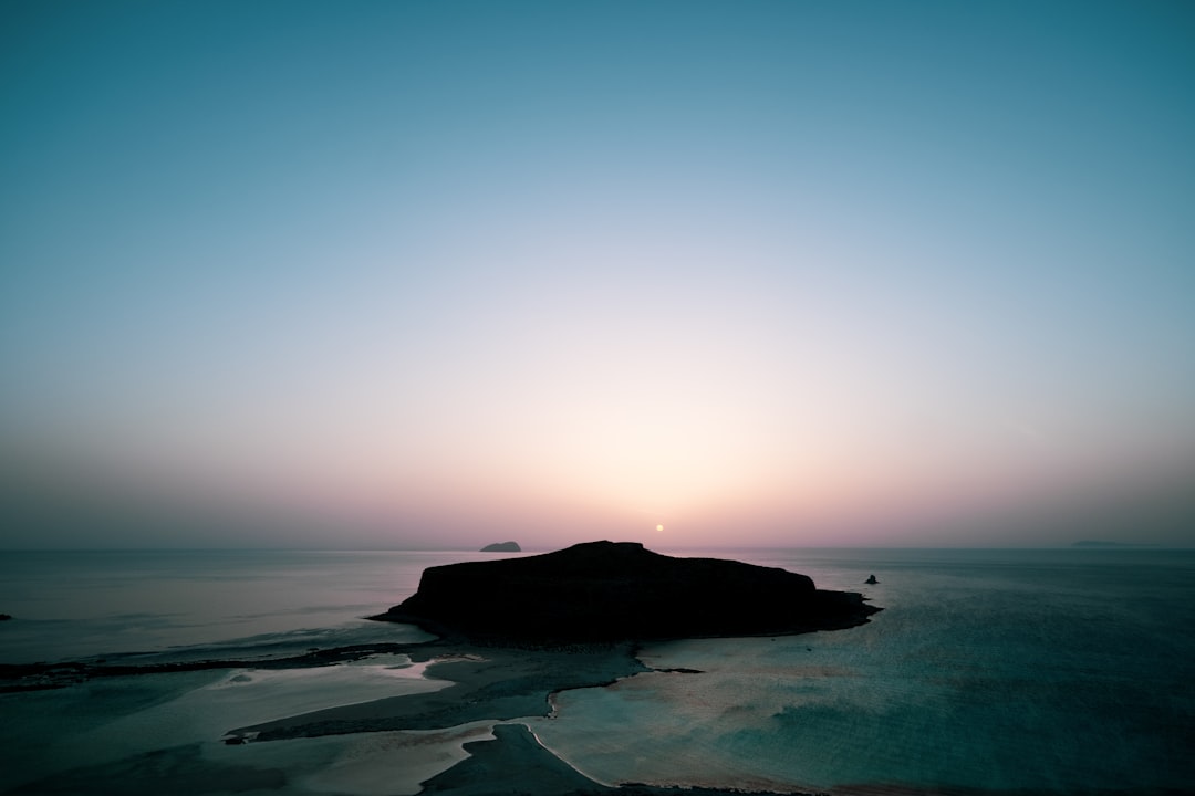 silhouette of islet across horizon