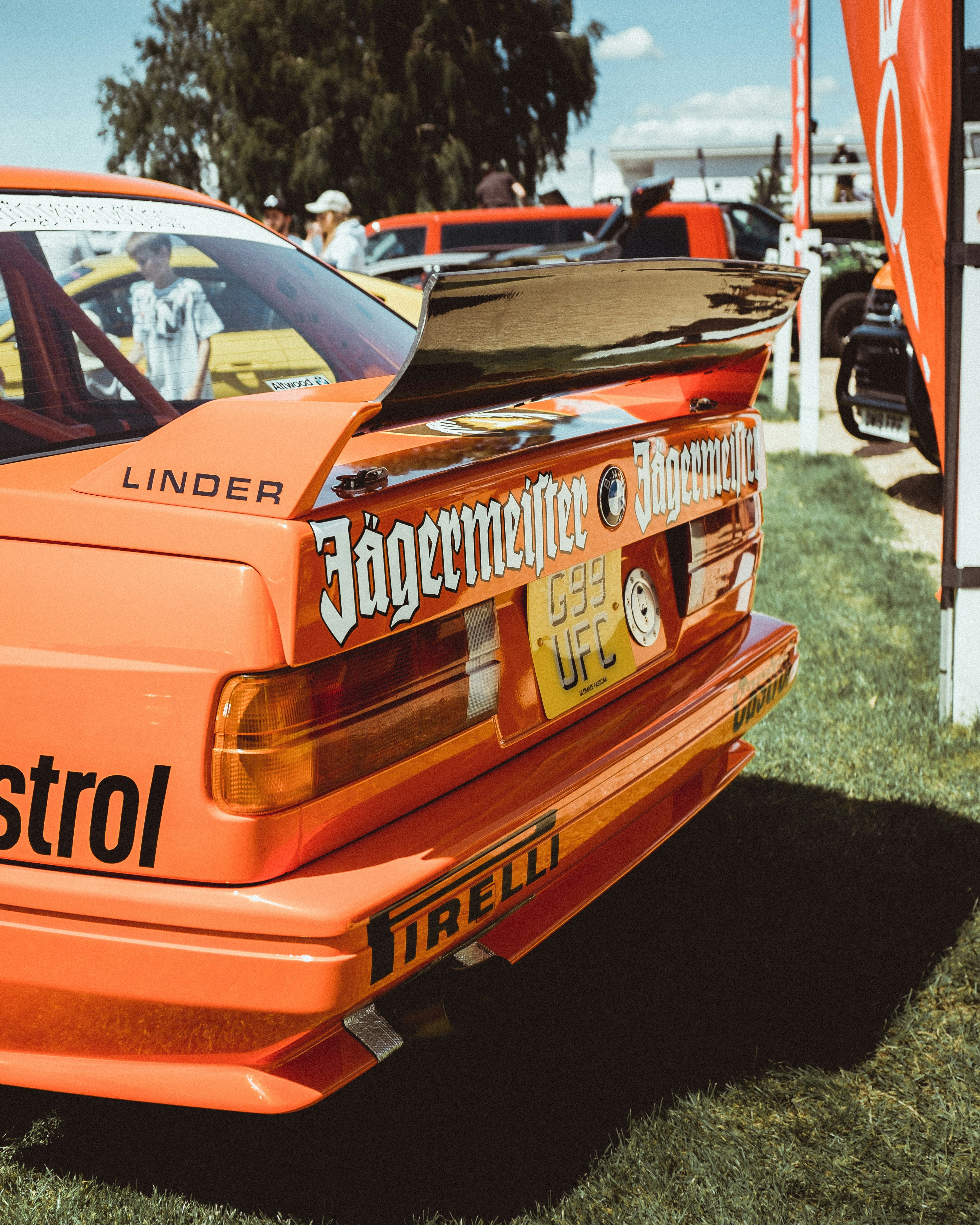 orange car parked near building