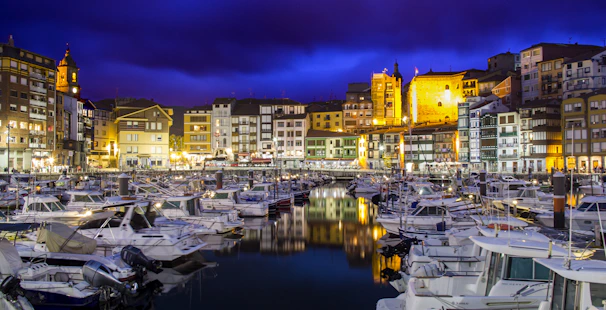 A panoramic view of Funchal’s colorful harbor at sunset with boats gently bobbing.