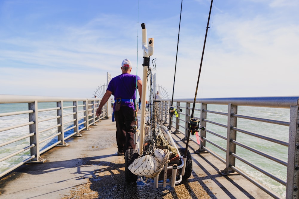 man fishing in dock during daytime
